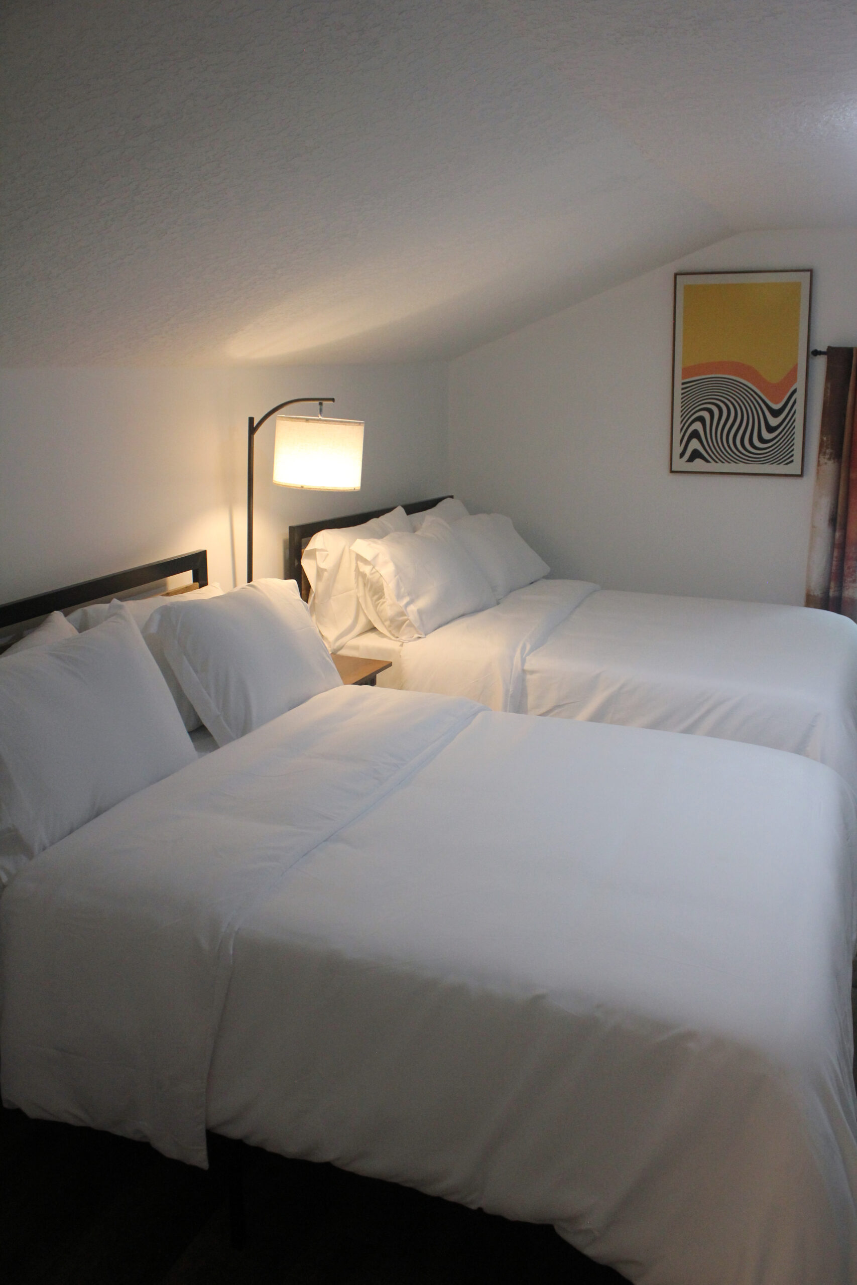Sunlit upstairs room with a writing desk near the window.