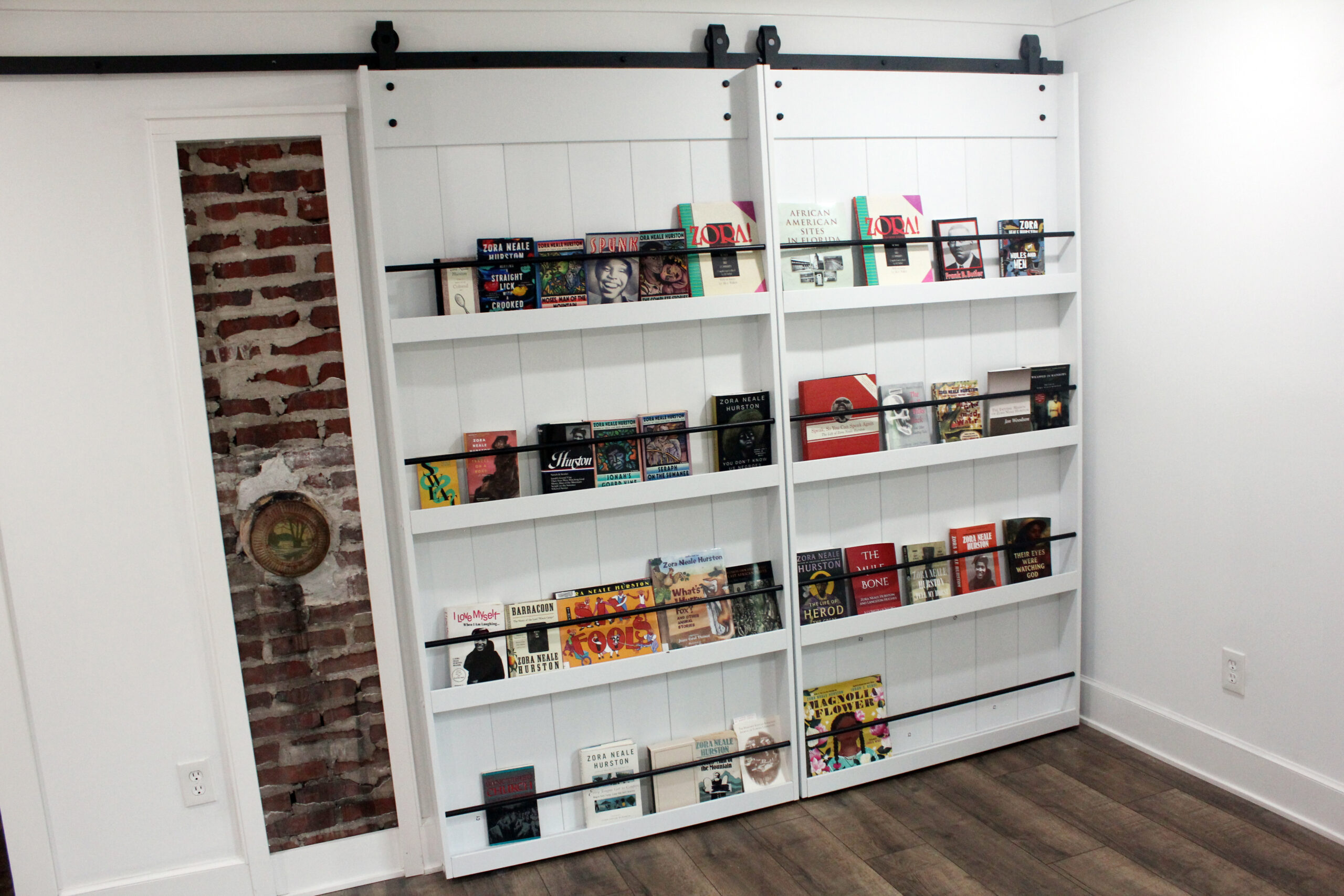 Downstairs room staged as a small museum with framed documents and photographs.