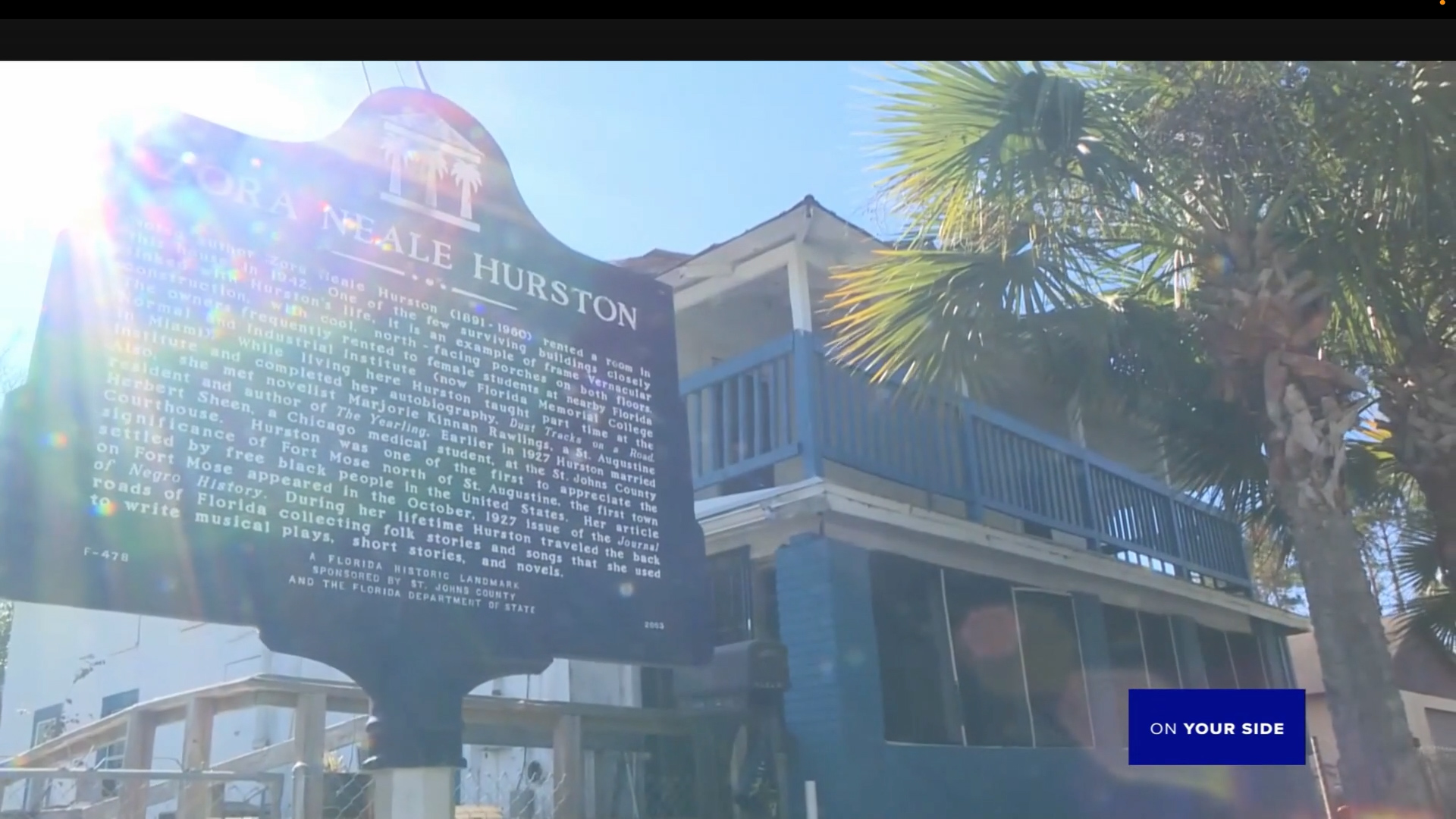 Evening exterior—warm light in the windows, museum sign at ground floor.
